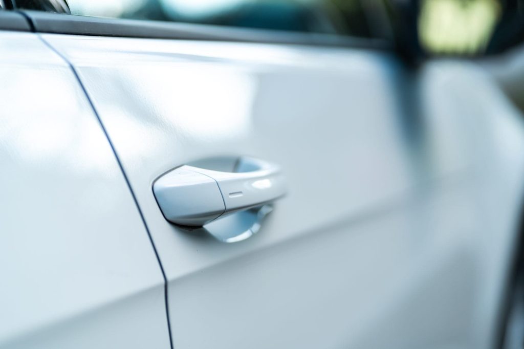 A smooth shiny silver car door in close up view