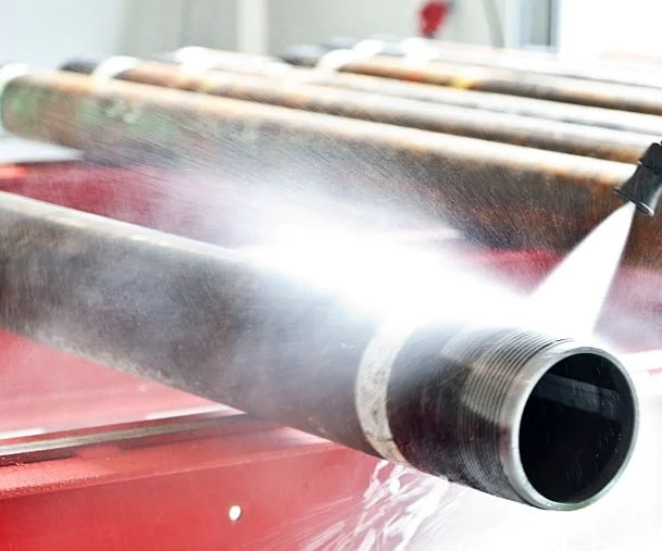 A powerful jet of liquid cleaning a metal tube