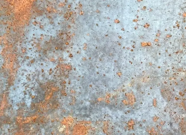 A metal sheet covered by spots of rust 