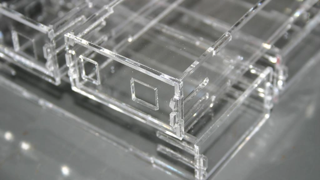 A end cross-section view of acrylic laser cut prototype; two rectangular holes on the face