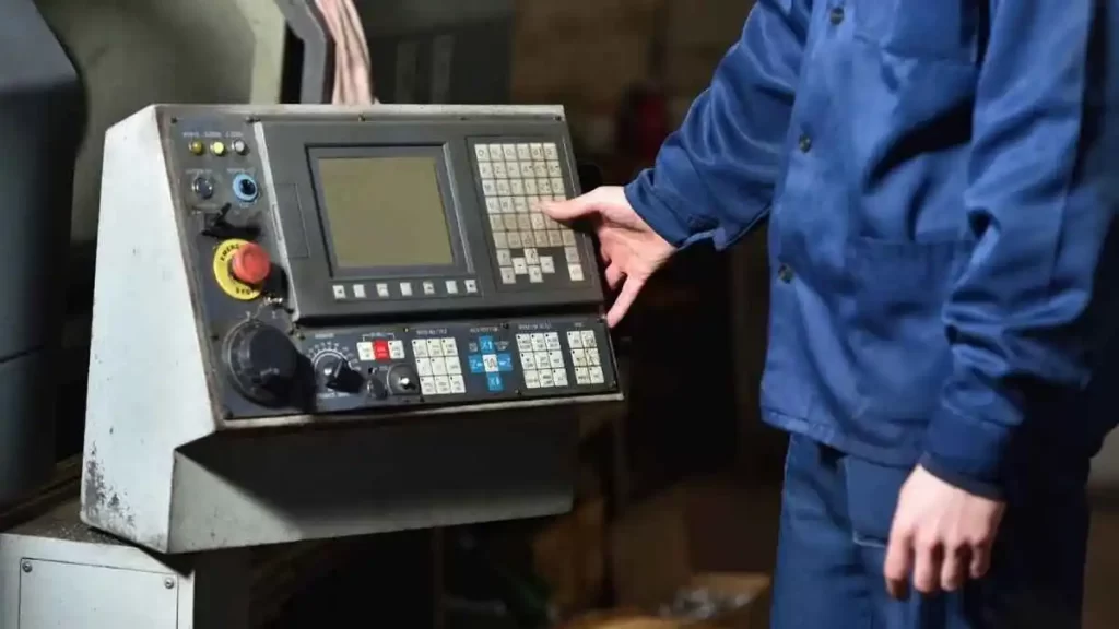 A close-up of an operator running an advanced CNC machine, to achieve high-end quality production results.