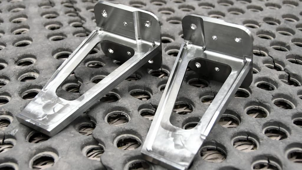 Two custom mounting brackets for aircraft with MAO finish, emphasizing the diverse applications of MAO.