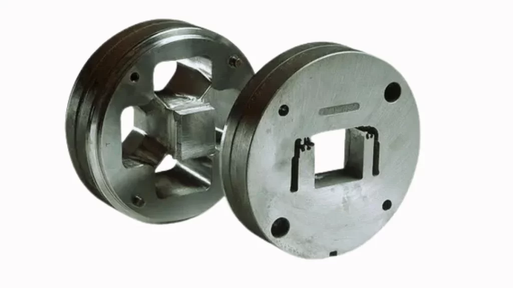 An image of aluminum extrusion dies used to shape aluminum profiles. The dies are commonly designed for consistent quality extruded part production