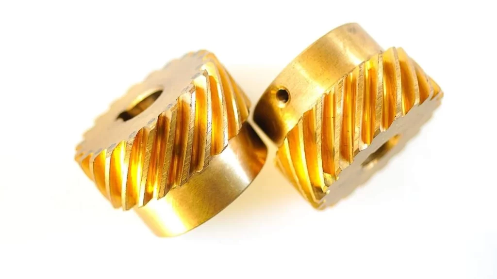 An image showing a pair of brass threaded machined parts with a precise finish