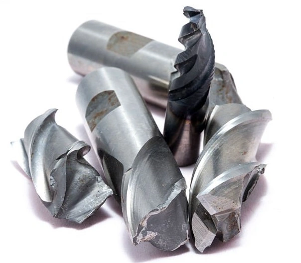 Several pieces of broken machining tools on a white background