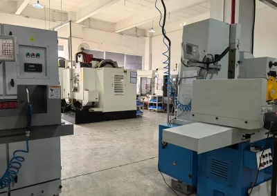 The image displays five CNC machining centers and one CNC grinding machine.