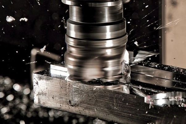 A milling tool removing material from a workpiece as chips fly off