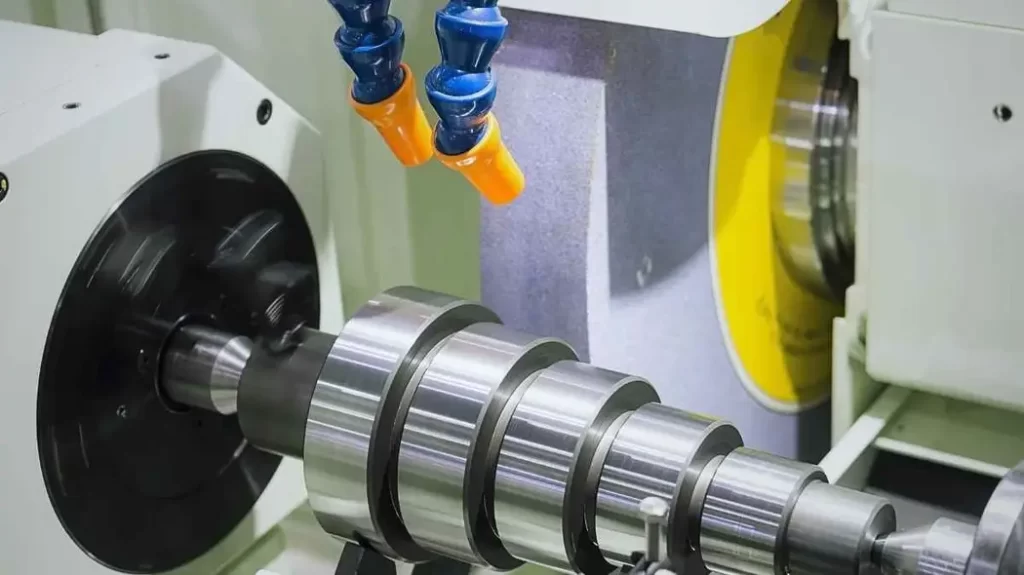 An image of CNC OD grinding. It shows a shaft being externally ground for a smooth finish