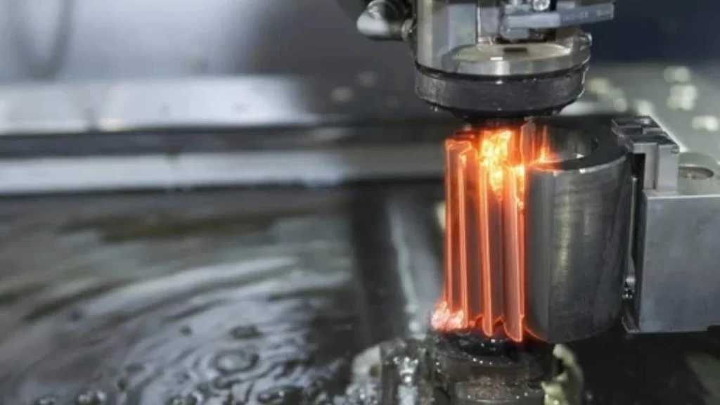 An image of CNC wire metal cutting. It shows Wire EDM machining in action, precisely cutting through a durable metal part