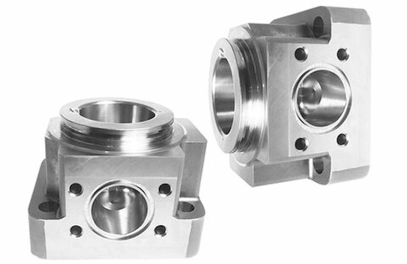 Two custom stainless parts made from 5-axis CNC machining: interrupted holes and threads as key features