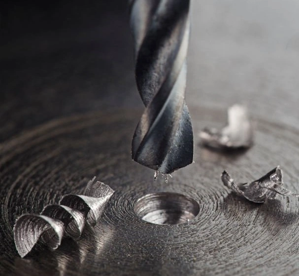 An image showing a hole machining process on a metal part involving a drill bit