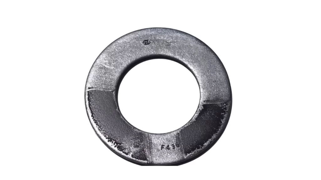 A close-up view of galling on an aluminum washer with the affected area