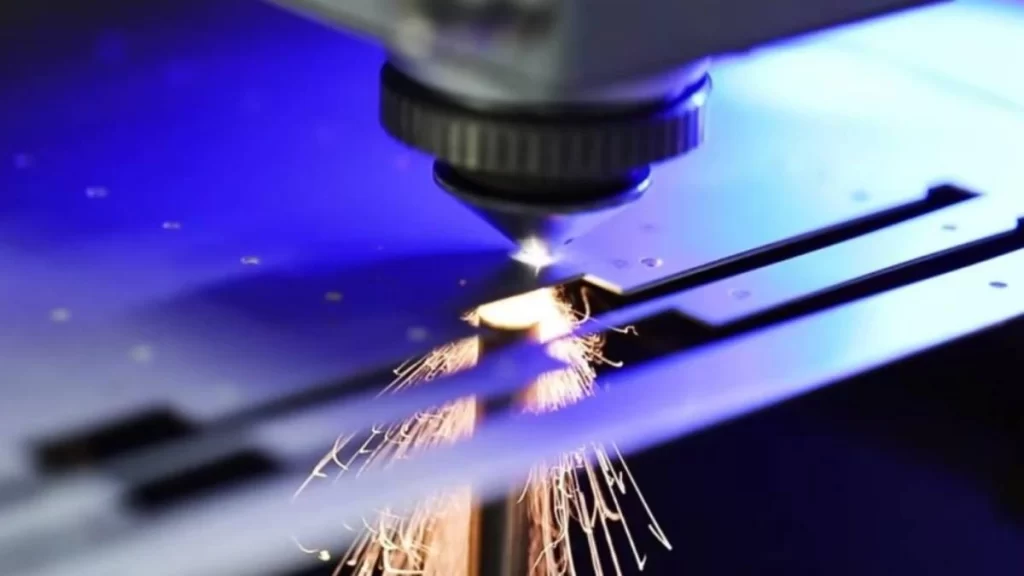 An image of high-speed sheet metal laser cutting. It shows a powerful laser swiftly cutting through a metal sheet with precision