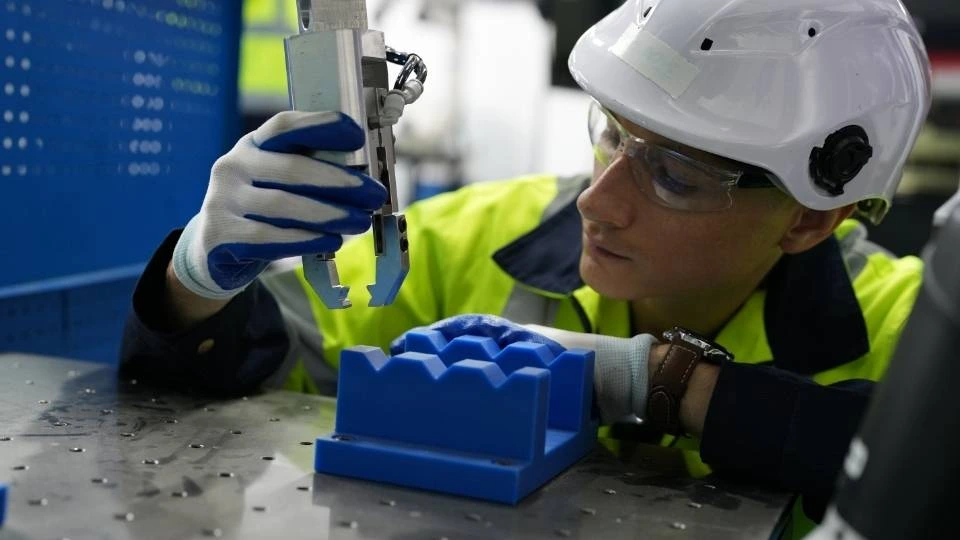 Manufacturer testing an injection molded product to ensure quality standards 