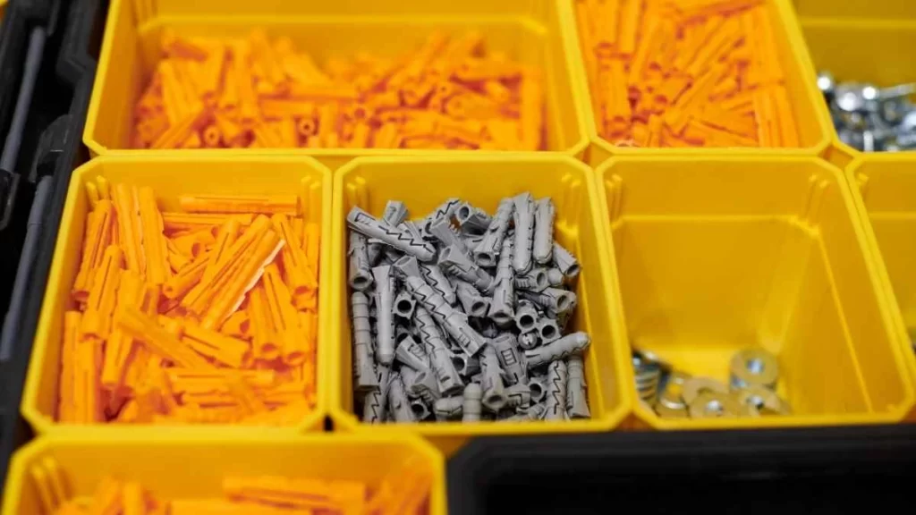 The image shows custom-quality molding pins/parts neatly placed in boxes. These seem like ready for inspection or shipment.