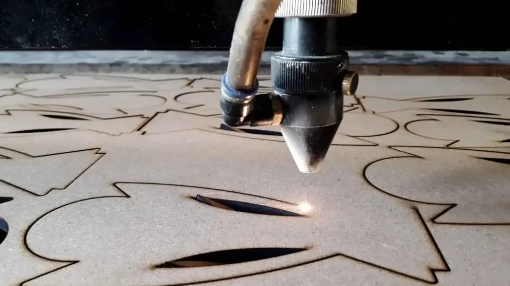 Close-up view of a laser marking process etching precise text and patterns onto a metal surface.