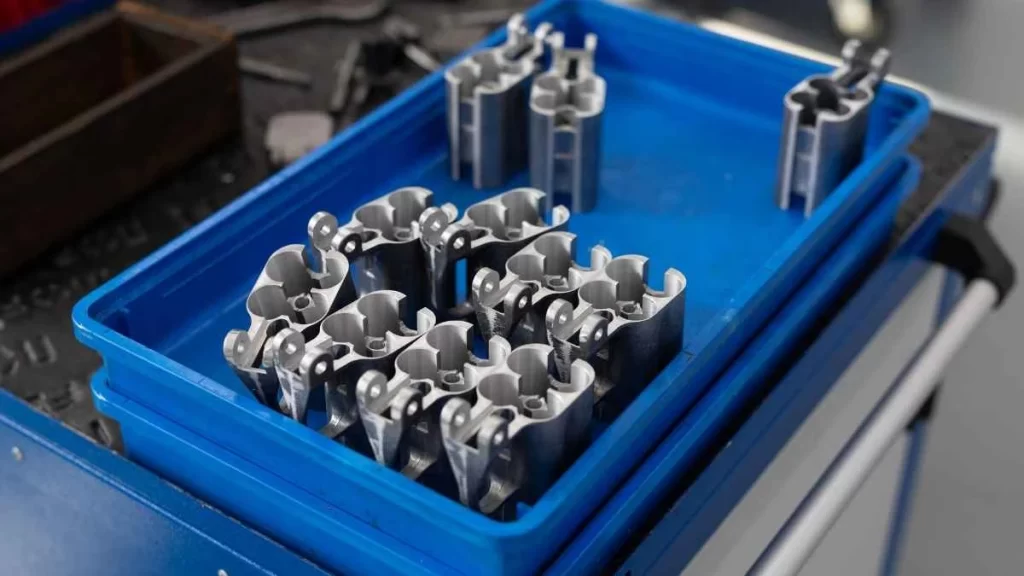 A tray displaying multiple identical high-quality parts manufactured through the Metal Injection Molding (MIM) process.