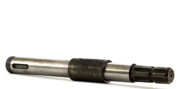 An image of a motor shaft showing a splined end, a slotted end, and a thicker middle section