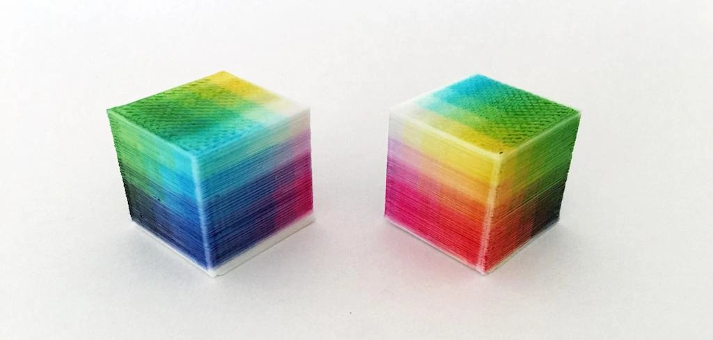 Two muti-colored 3d printed cubes side by side