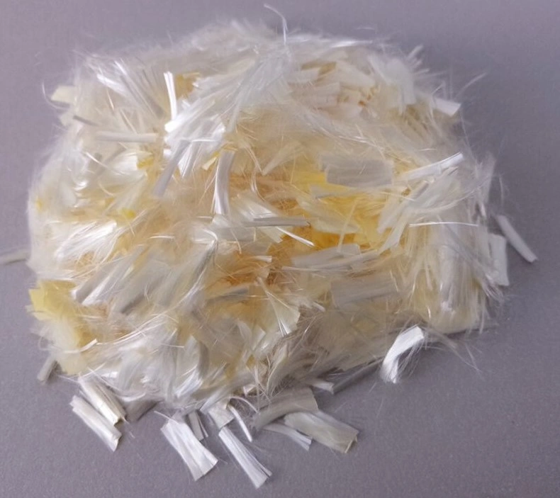 An image of a bundle of blonde hair-like fibers on a grey surface