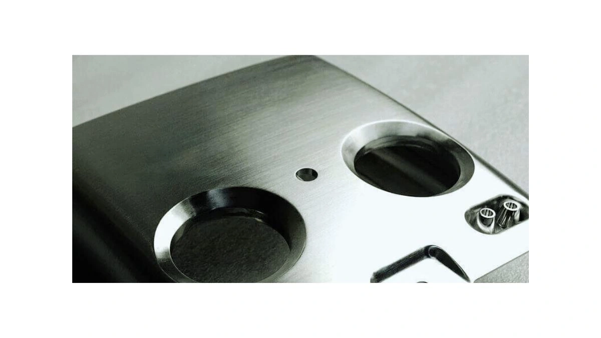 A close view of a polished metal surface reflecting a soft highlight across the face
