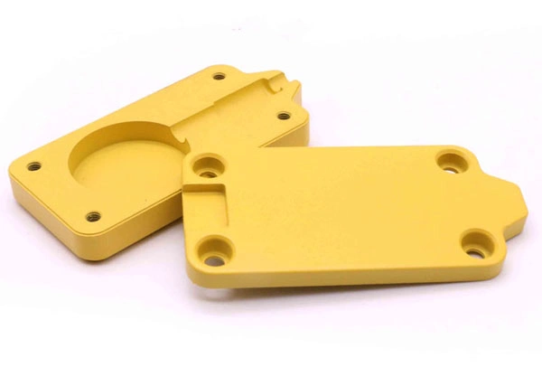 Two yellow-colored aluminum parts after powder coating finish