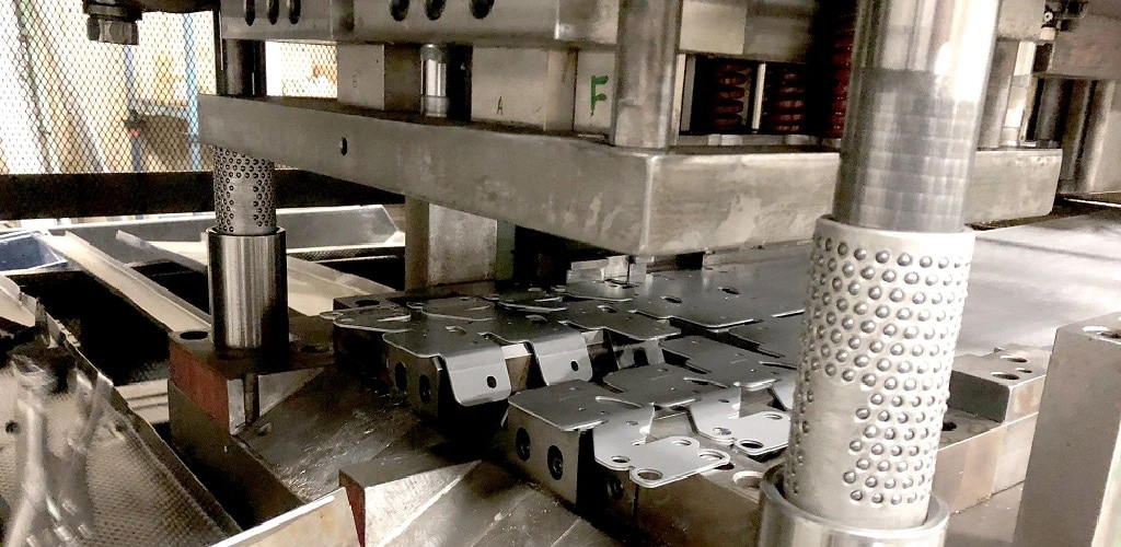 A close-up view of metal stamping setup parts in between die and punch