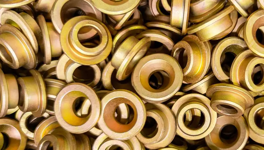 Round yellow zinc plated metal pieces arranged in a cluster