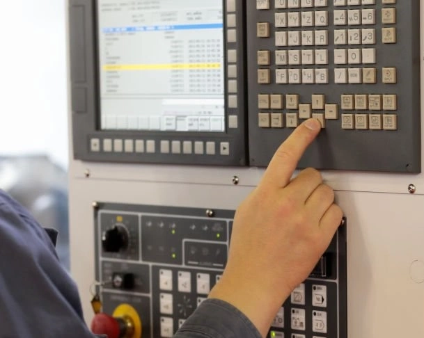  A person inserting digits on a panel of machine