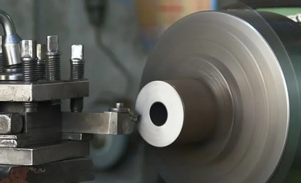 A face-turning tool removing material from the face of a fast-rotating workpiece