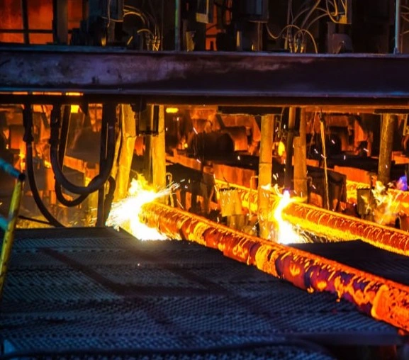 Metal shafts being heat treated and cut