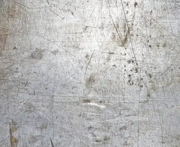 An image of a dented and scratched surface metal surface