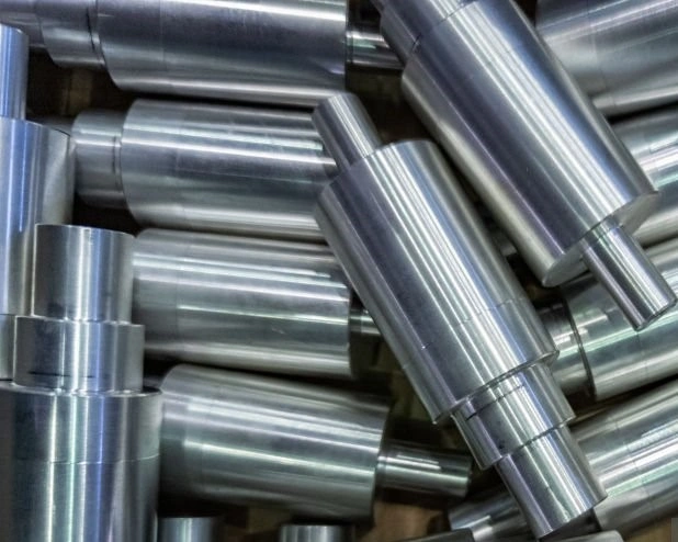 A closeup image of many shiny surface finished metal shafts 