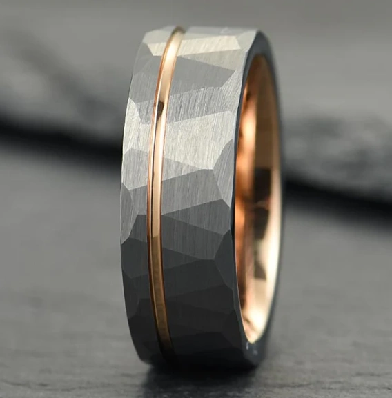 A grey ring with details and a narrow golden-colored strip