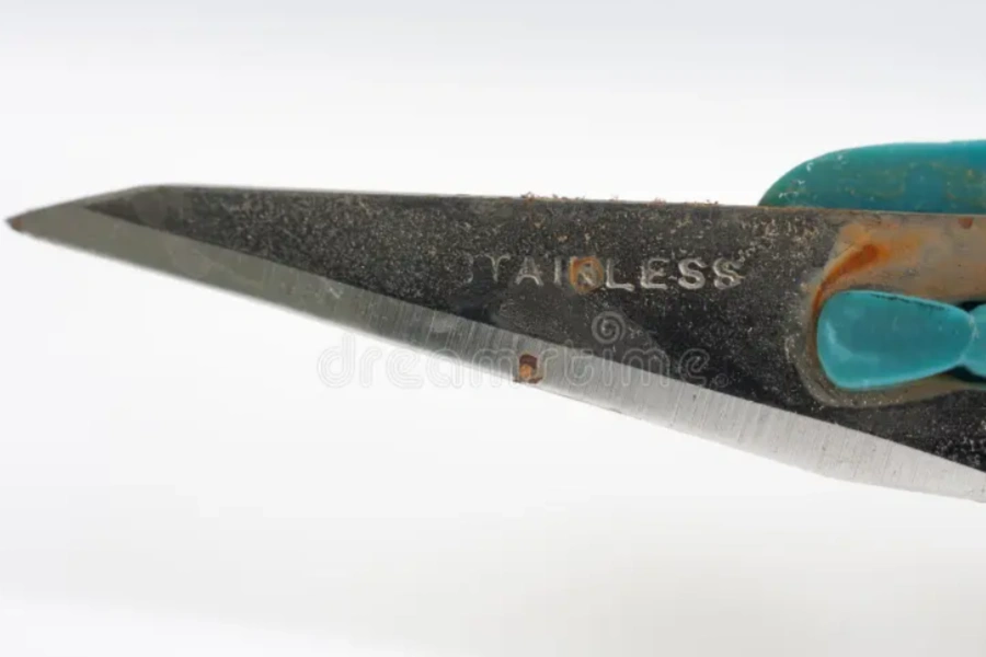 A close-up image of a rusty stainless steel scalpel with a green handle