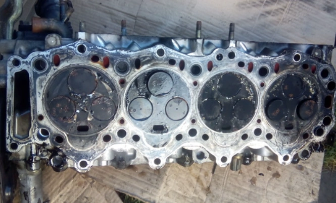 A disassembled cylinder head showing signs of overheating