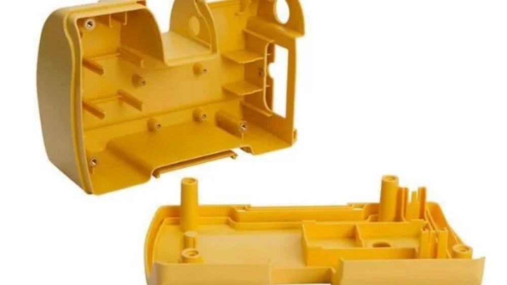 An image of a polypropylene (PP) injection molded enclosure (coloured in yellow). It showcases its durable structure and precise molding details