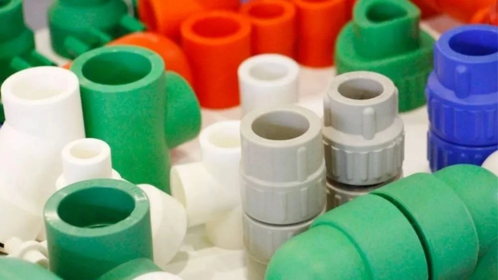 An image of PP injection molded piping accessories, including pipe fittings and connectors