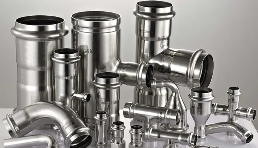 Several SAE 304 stainless steel pipe fittings placed on a surface