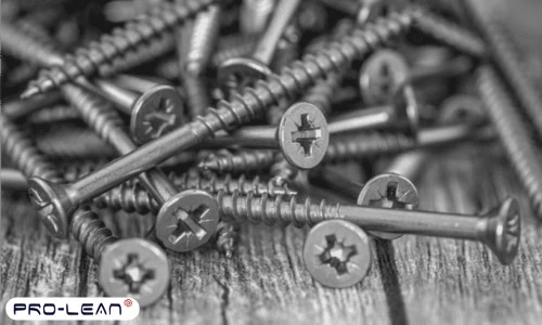 A close-up of steel screws on a table