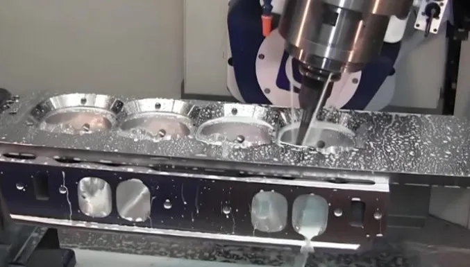 A milling machine performing high-speed precision cutting on a cylinder head