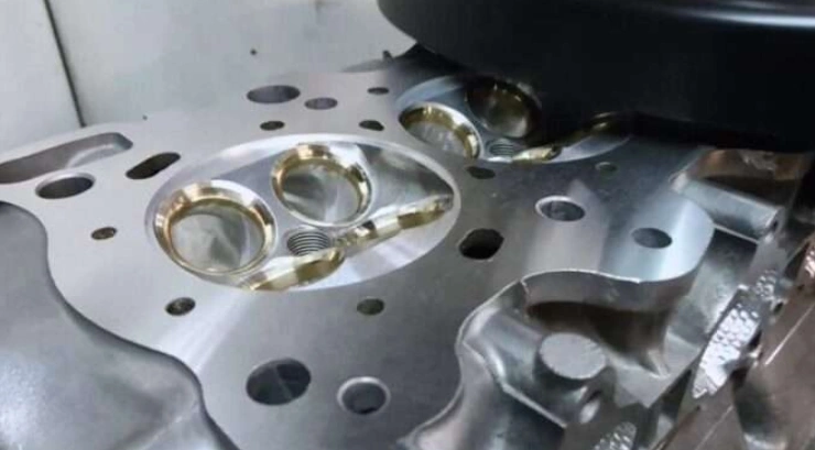 A resurfacing machine milling on a cylinder head