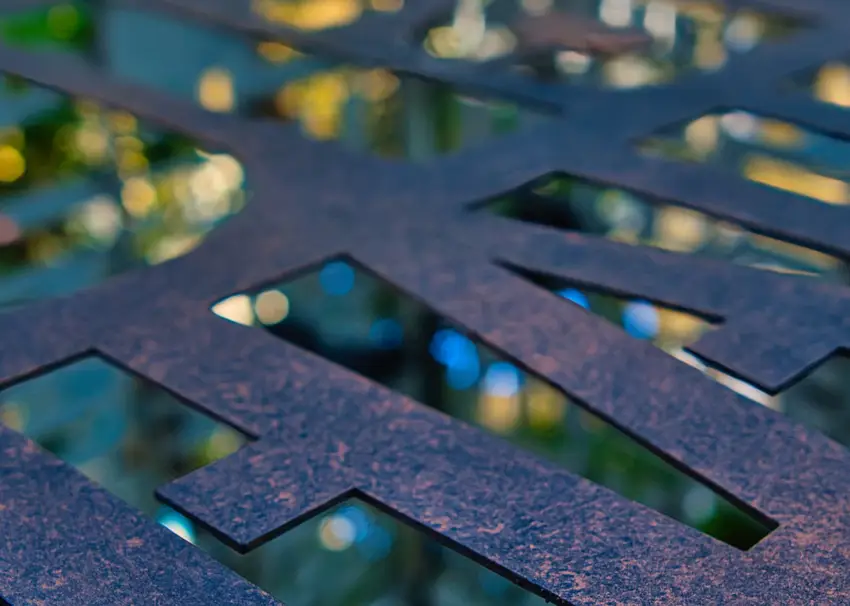 A close-up image of a metal stencil showcasing geometric cutouts