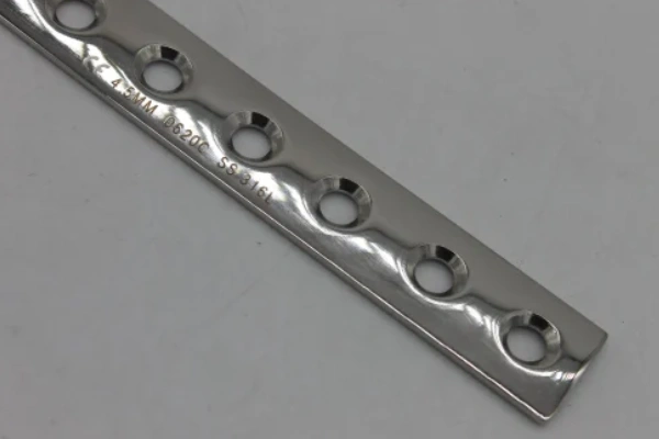 An image of a holed stainless steel orthopedic implant plate