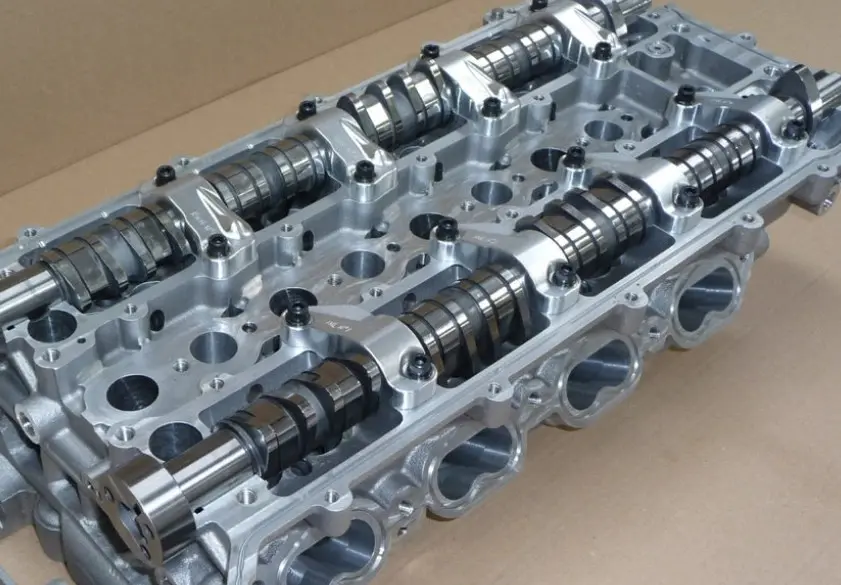 An image of a DOHC (Dual Overhead Camshaft) cylinder head assembly