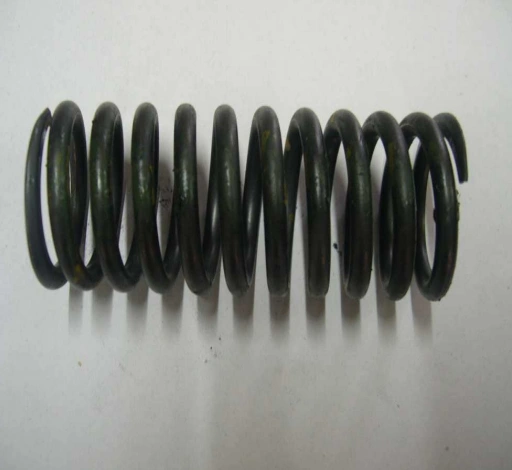 A black helical valve spring made of metal