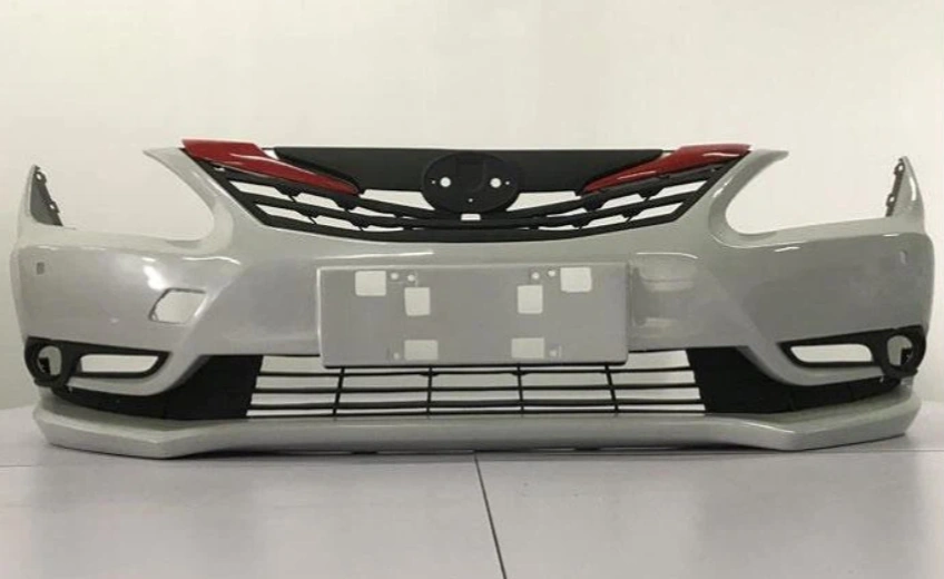 A white car bumper with black and brown sections, manufactured through SLA 3D printing