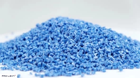 Pile of blue ABS plastic pellets used in manufacturing processes.