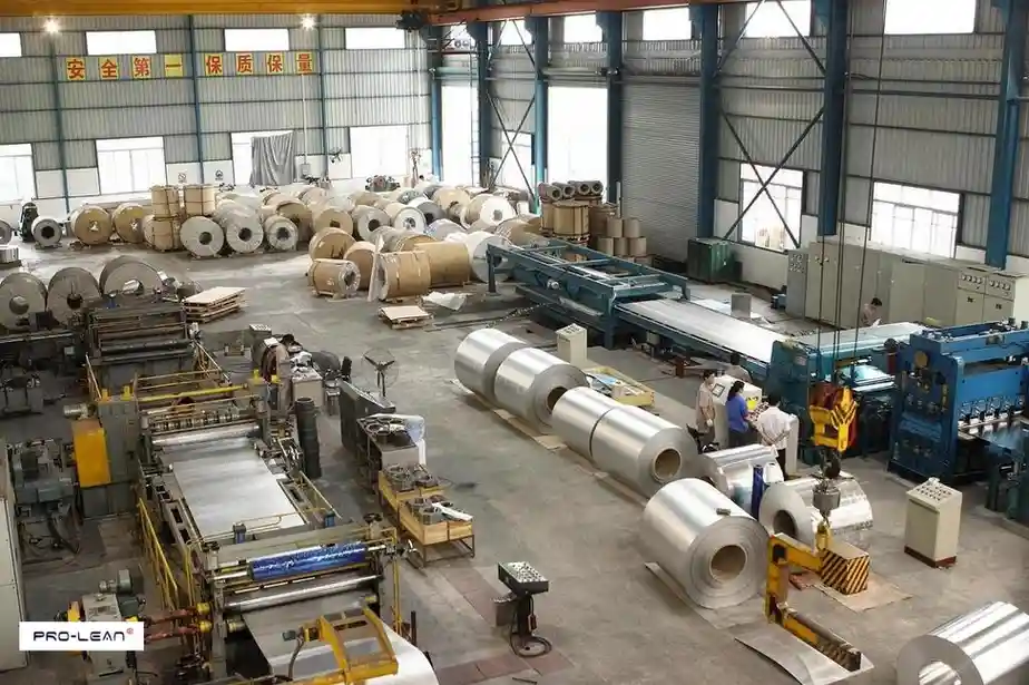 Large industrial facility with aluminum coil processing machinery.