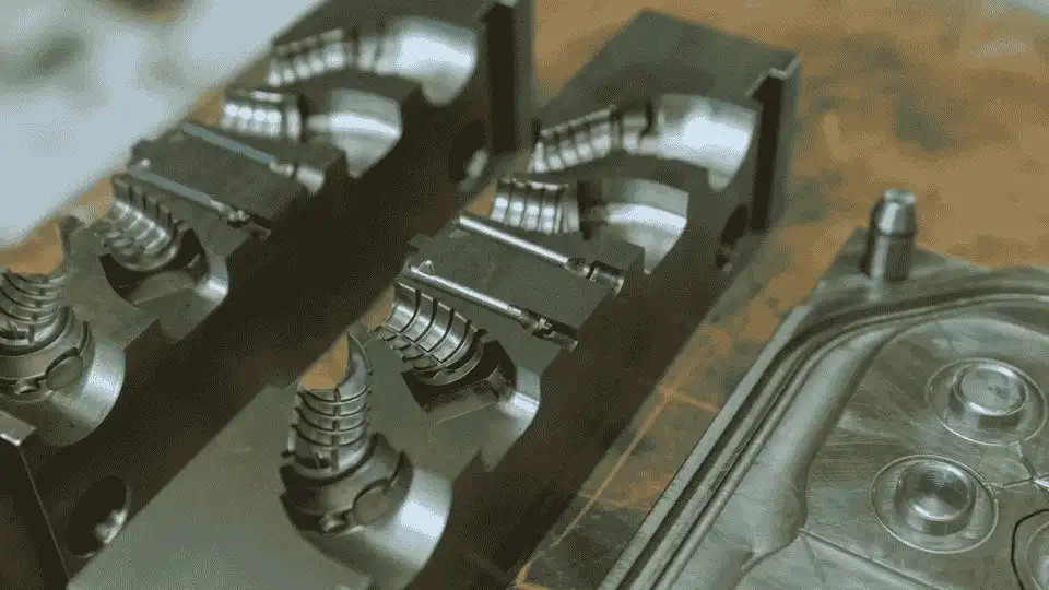 Image of a simple compression mold design used to shape materials.